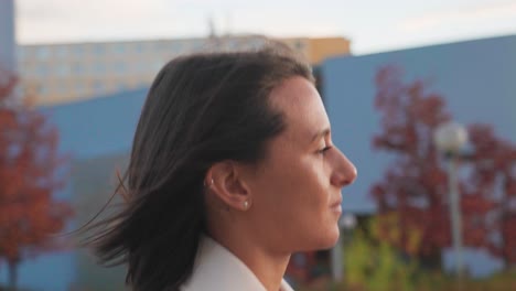 Close-up-of-serious-female-brunette-face-during-outdoor-city-walk,-Prague