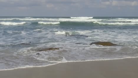waves creeping up on the beach in slow motion