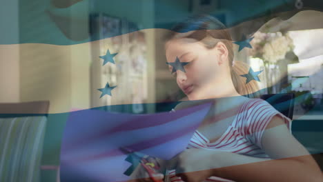 cutting paper with honduras flag overlay, child creating animation in school