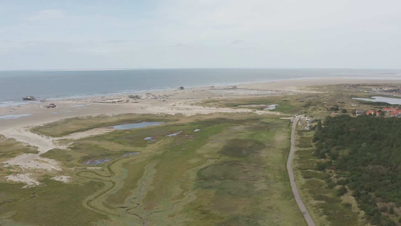 Drone - Aerial shot of the green and sandy nature beach of St. Peter Ording at the north sea, schleswig holstein, germany, 30p