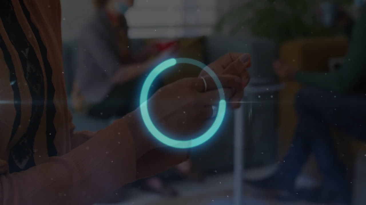 Hand pointing with digital interface animation over people sitting in background