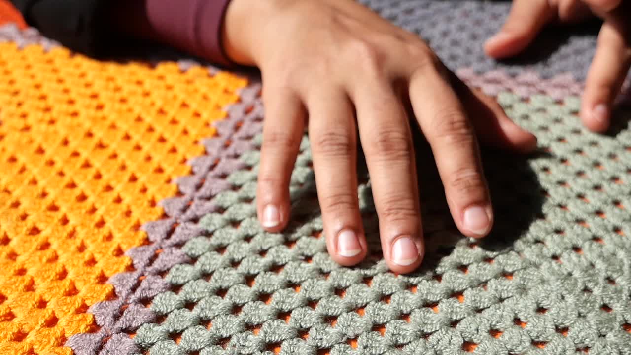Person's Hand on Crochet Blanket