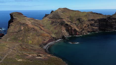 Aerial-view-following-colourful-volcanic-mountain-range-of-Ponta-de-sau-Lourenco-island,-Madeira