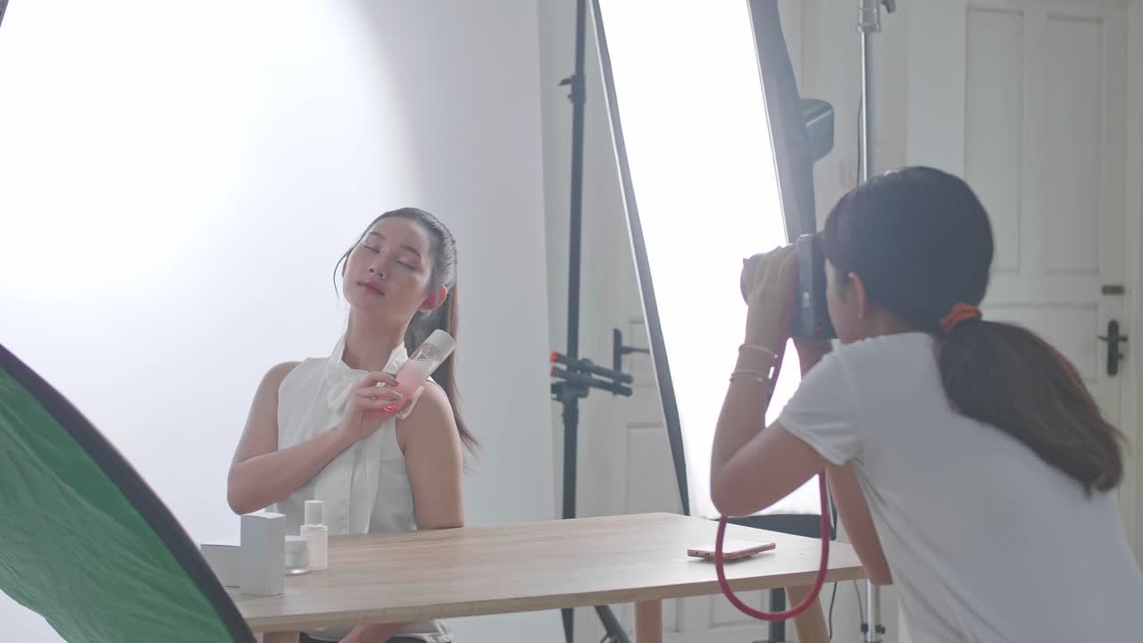Behind The Scenes On Photo Shoot: Beautiful Asian Model Poses For A Photographer, She Takes Photos With Professional Camera
