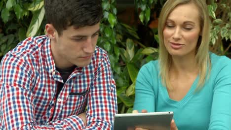 Students-using-tablet-outside-on-campus