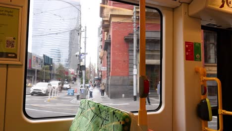 tram passing by cityscape and advertisement