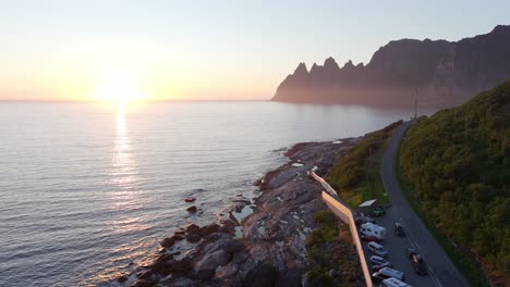 cars parked on the road in tungeneset during sunset in senja island, norway