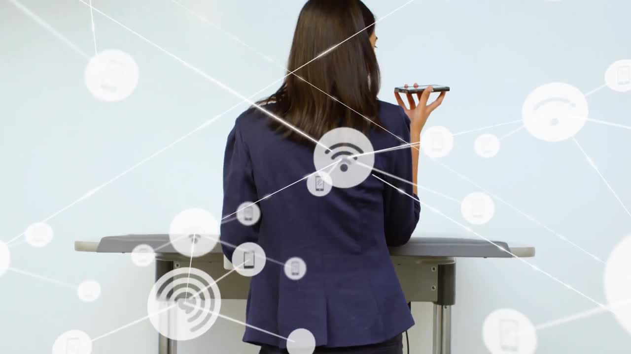 animación de iconos conectados sobre la vista trasera de una mujer biracial de pie y hablando por teléfono celular.