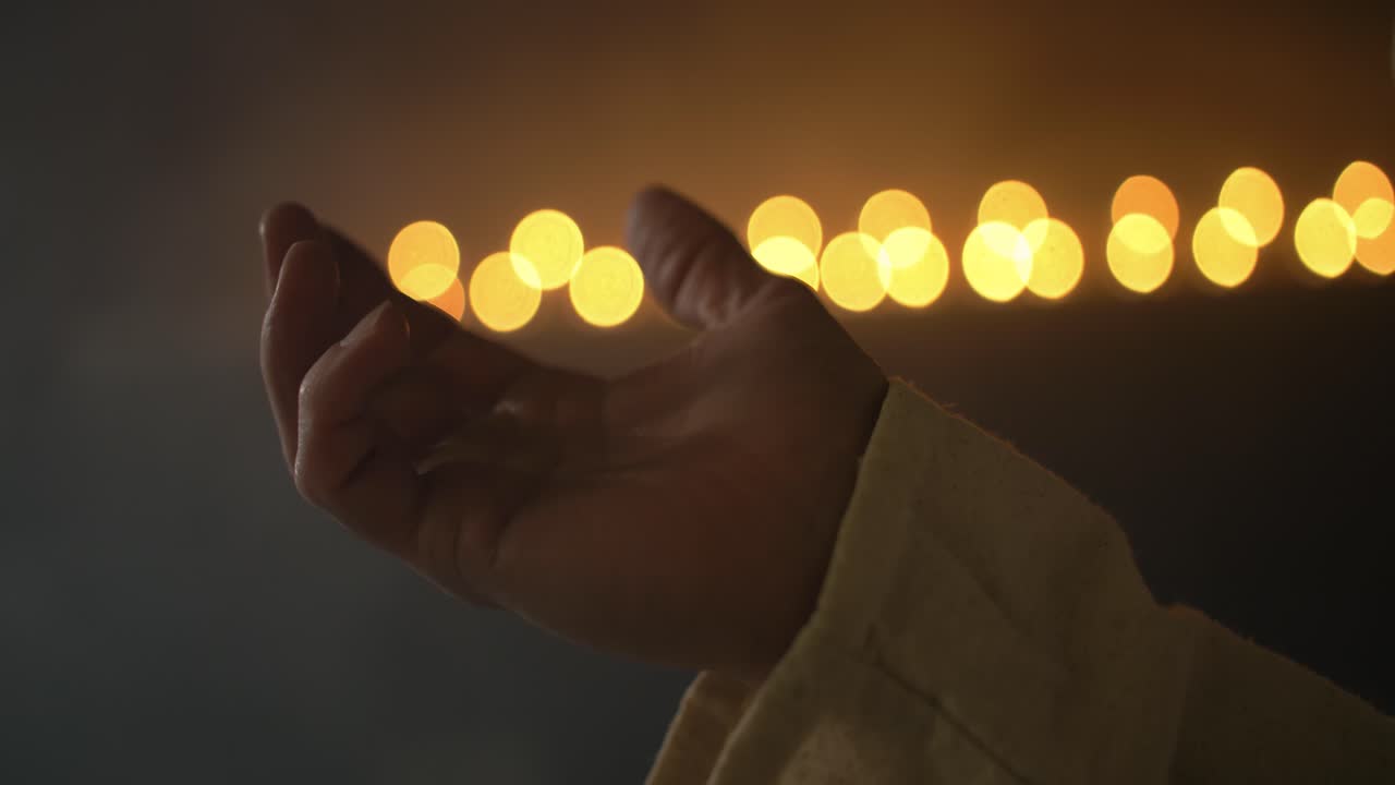Closeup of hand lifted in prayer, worship, for Christianity stock footage