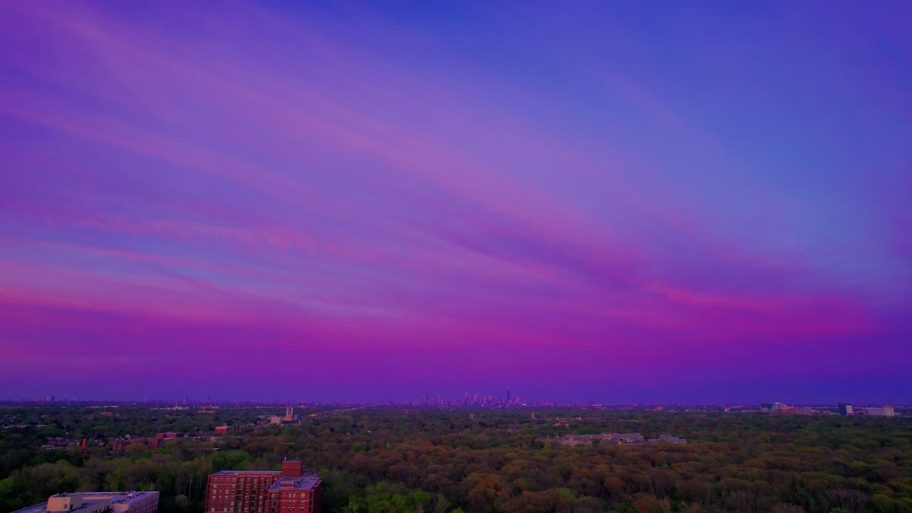 Melrose Park suburbs toward Chicago skyline at dusk.