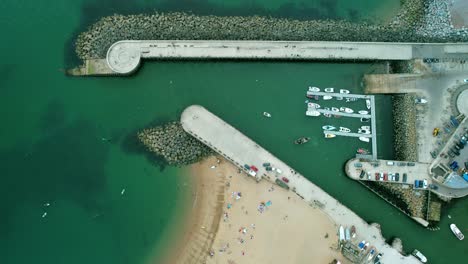 aerial above bridport harbour pier and west bay beach in dorset, england