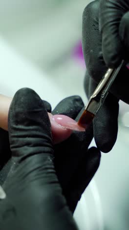 woman in a nail salon receiving a manicur