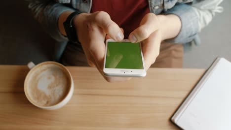 man using smart phone with green screen