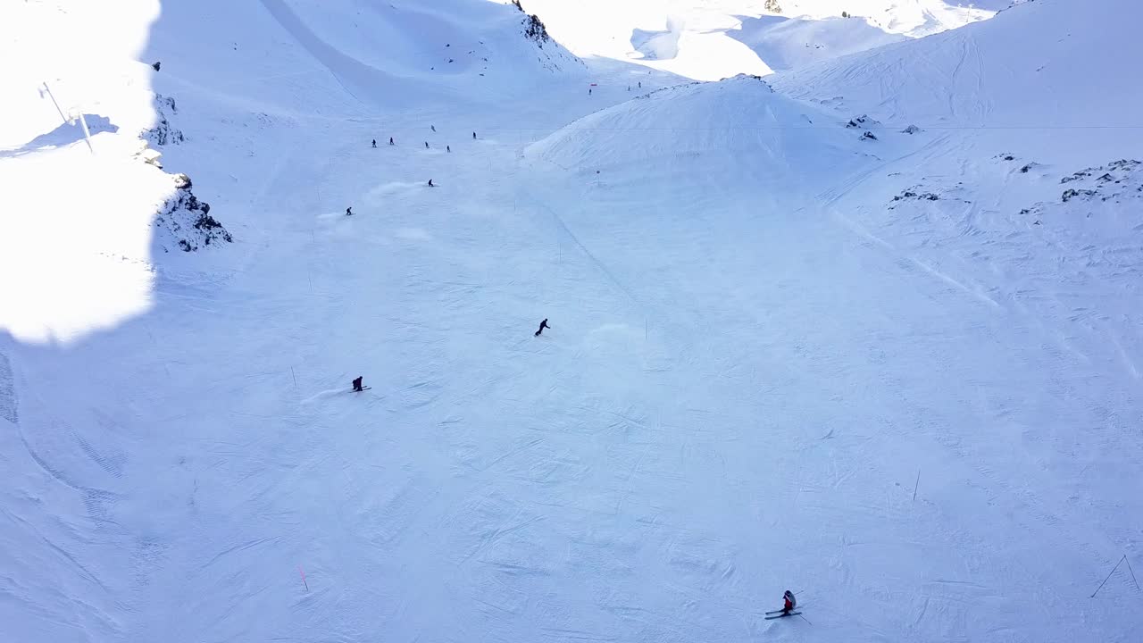 Skiers and snowboarders on a snowy mountain slope