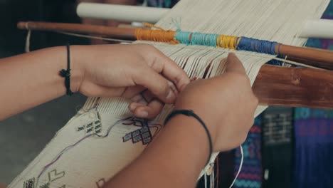 manos tejiendo telas tradicionales usando telar de cintura en guatemala, américa central - cerrar