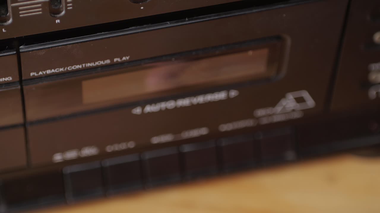 Retro radio tape recorder, audio cassette close-up. Listening to music, old radio boom box player, macro of vintage music listening.