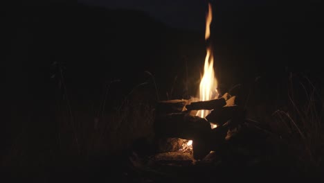 close up shot of burning bonfire at night after hiking in the mountains