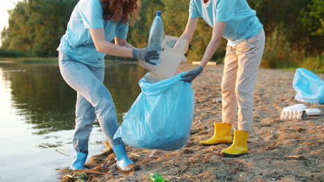 volunteers cleaning up beach/riverbank