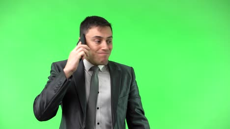 businessman talking on smartphone on green screen