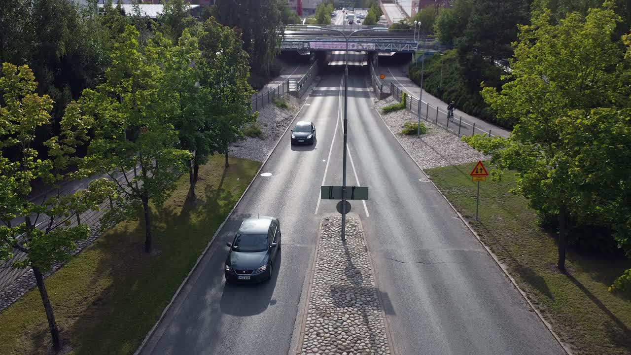 Aerial View of a City Road with Cars and Trees