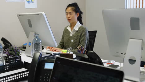 animation of network of connections with people icons over asian businesswoman in office