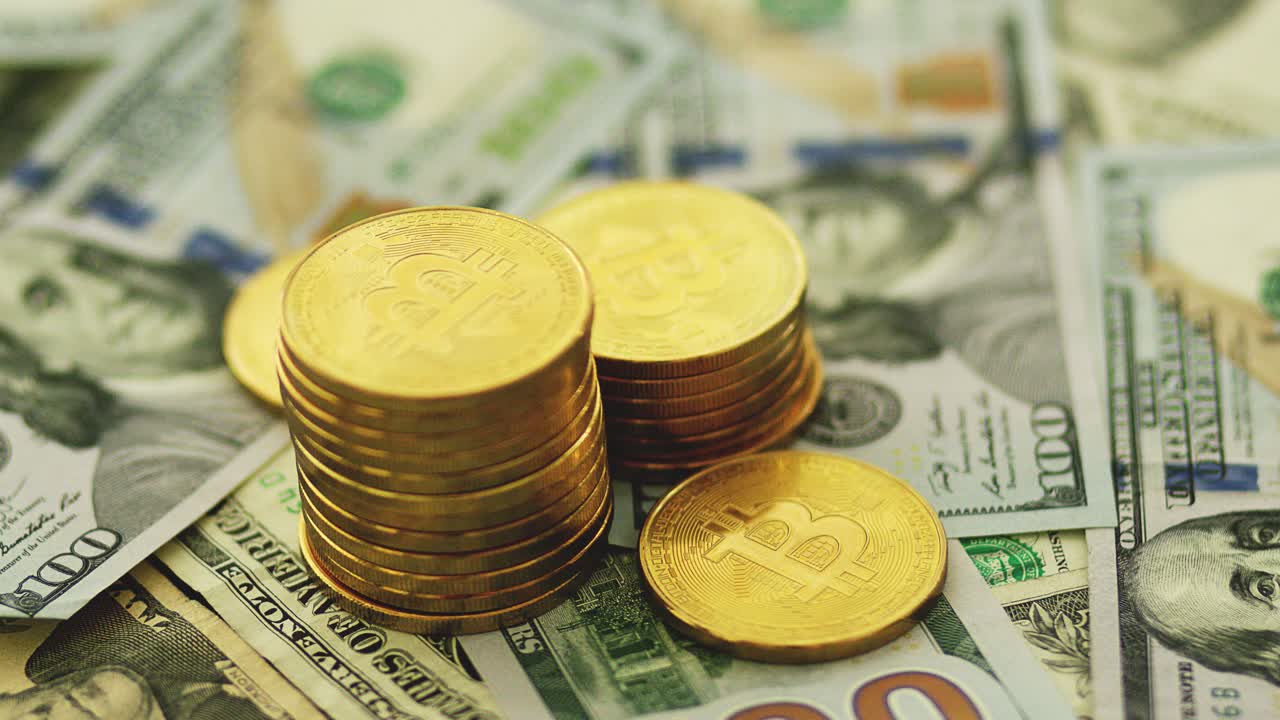 Stack of golden bitcoin on bills