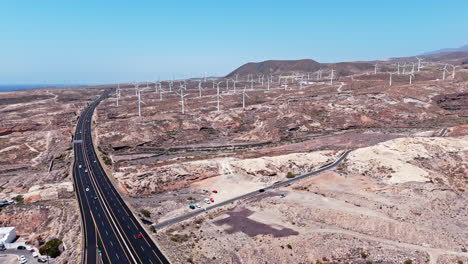 Aerial view of wind turbines in Tenerife's arid landscape on a sunny day