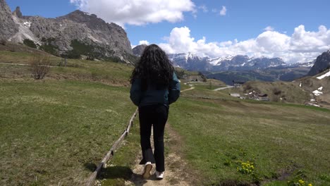 rear view of a woman walking on trail in the italian dolomites
