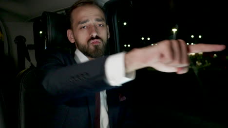 happy businessman in suit dancing in the back seat of his luxury car with personal driver