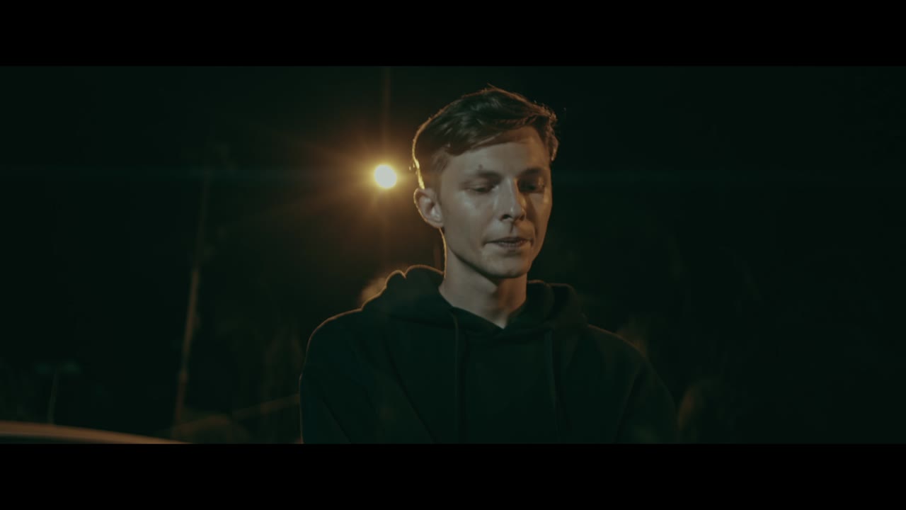Young man in hoodie at night