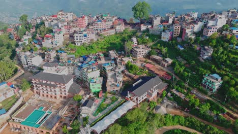 drone video captures the stunning manakamana hill in gorkha, nepal—home to the sacred hindu temple, surrounded by dramatic hilltop views, traditional villages, and a famous cable car route