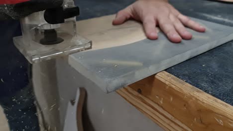 A-woodworker-uses-a-router-on-a-wood