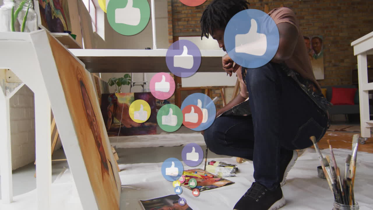 Painting on canvas, artist surrounded by floating thumbs-up animation