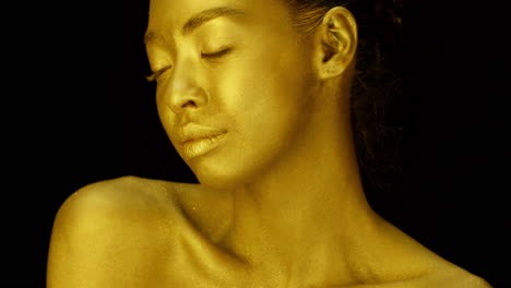 gold body paint portrait of a woman
