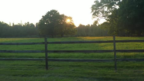 trucking-shot-of-a-fence-at-sunset-near-the-Joseph-Smith-family-farm,-frame-house,-temple,-visitors-center,-sacred-grove-in-Palmyra-New-York-Origin-locations-for-the-Mormons-and-the-book-of-Mormon