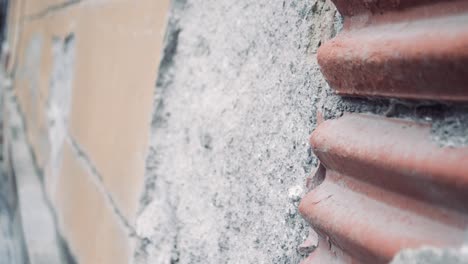 crumbling wall of the old building in a small town, close up