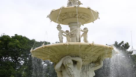 water fountain with statues in a garden