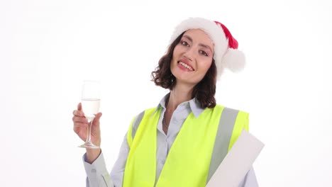 woman in santa hat and safety vest celebrating with champagne