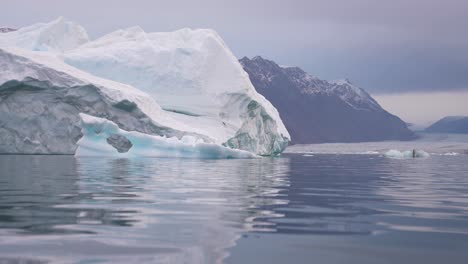 iceberg and cold north sea water in fjord of svalbard island archipelago, norway