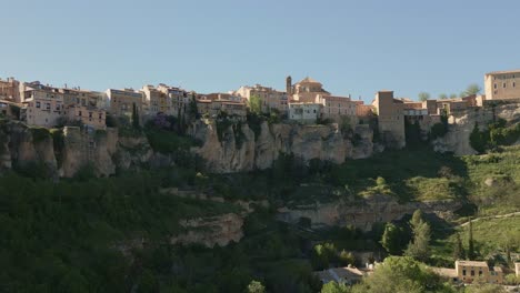 houses hanging next to rocky precipice. zoom in aerial view of medieval houses next to a cliff. cuenca. spain.