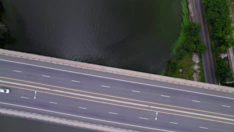 aerial view of new highway bridge over lake with cars moving on road