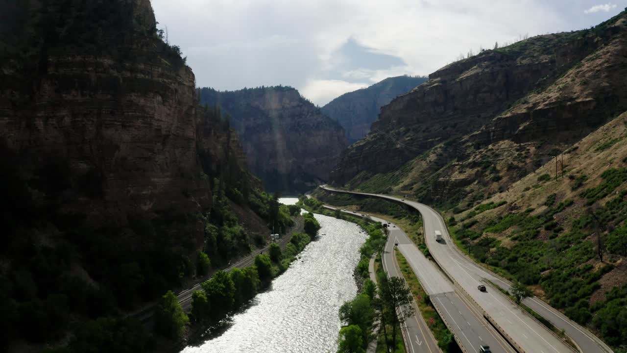 Drone shot of Interstate 70 running parallel to the Colorado River through Glenwood Canyon