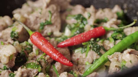 chicken or pork stew with red and green pepper onion, and spices cooking in a frying pan. traditional mexican cuisine, tacos preparation, ragout.