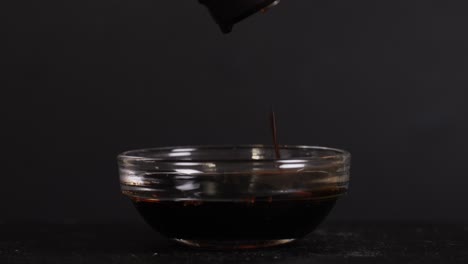soy sauce pouring into a bowl