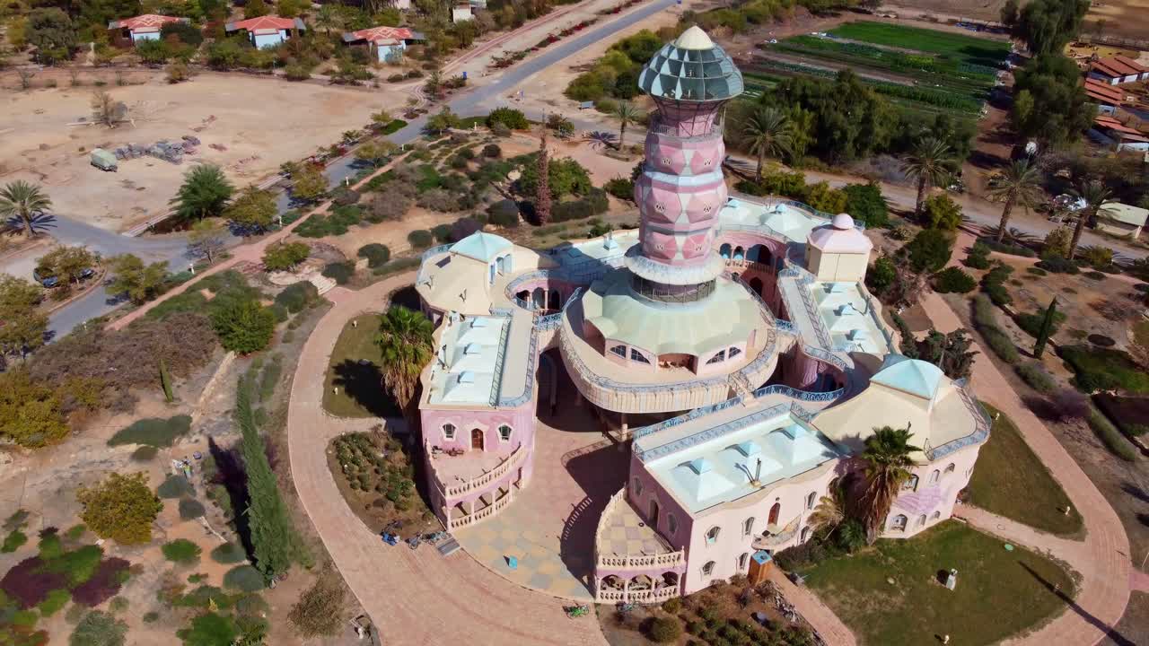 Neot Smadar Arts Center building from above surrounded by garden, and agricultural lands in Arava desert in summer, Drone view