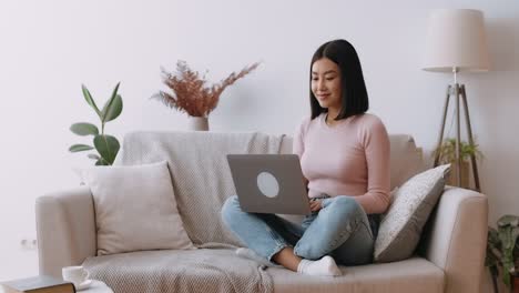 young woman working from home on laptop