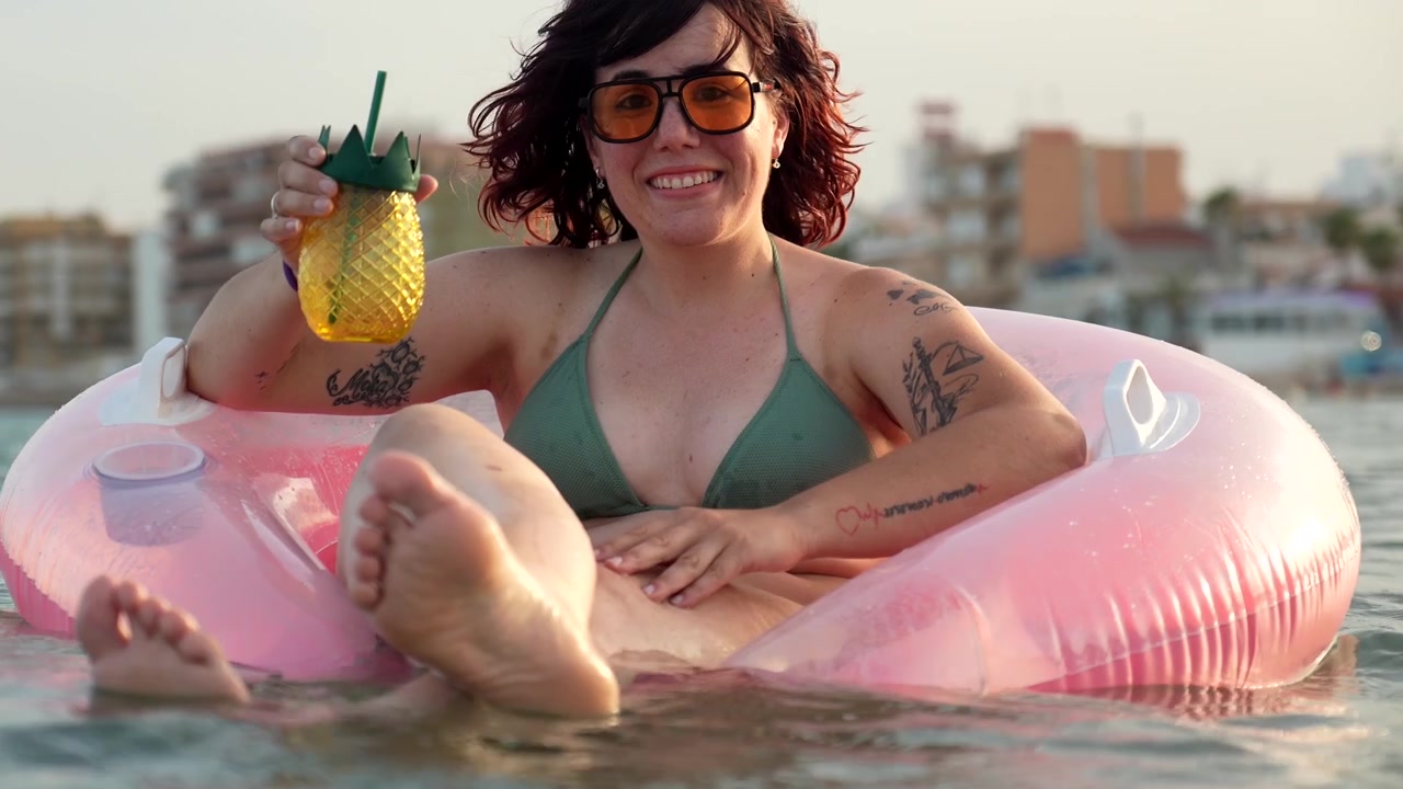 Young Woman Relaxing on Inflatable Ring in the Sea