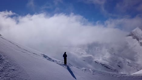 Sweeping-Shot-of-Person-standing-On-a-Mountain