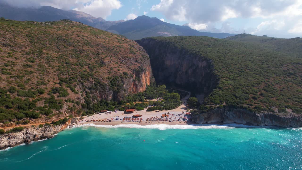 Paradise beach of Gjipe in Southern Albania, clean turquoise sea water splashing on beautiful bay