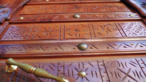 ornate moroccan entrance wooden door, low angle, slow motion